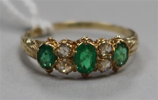 A 15ct gold, emerald and diamond seven stone ring, size O.